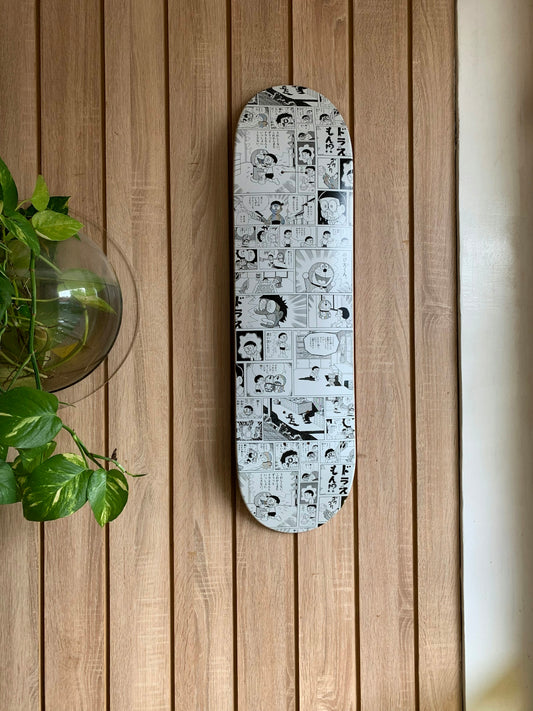 white and black skateboard deck on wall