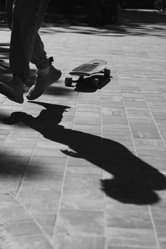 A person riding a skateboard on a sidewalk