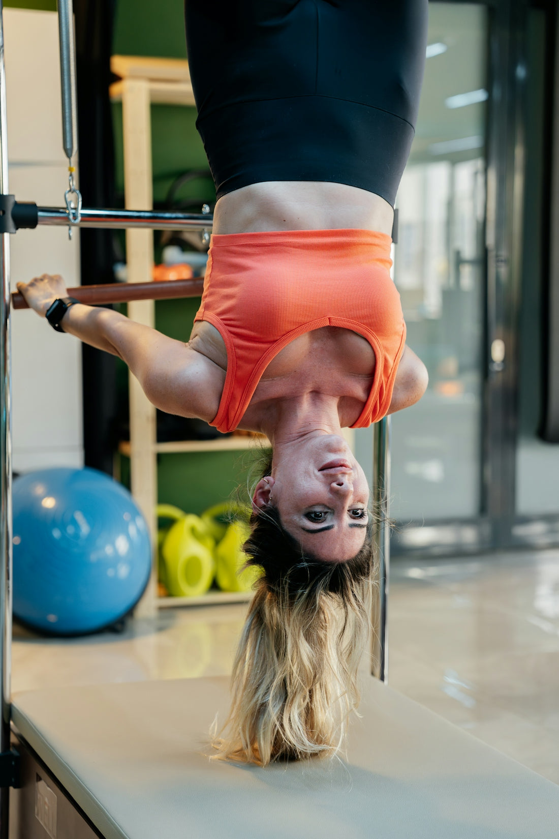 Woman inverting while doing pilates.