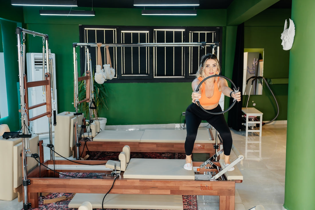 Woman is working out at a pilates studio.