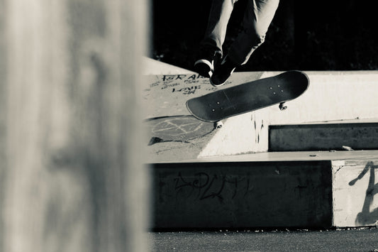 Skateboarder mid-air over concrete obstacle